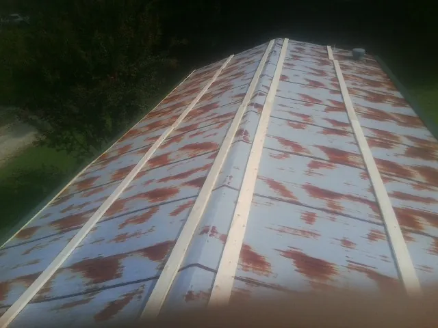 Rusted metal roof panels with new wood purlins before replacement — Storm Damage Roof Repair in Pacific Beach by Roofing Brothers